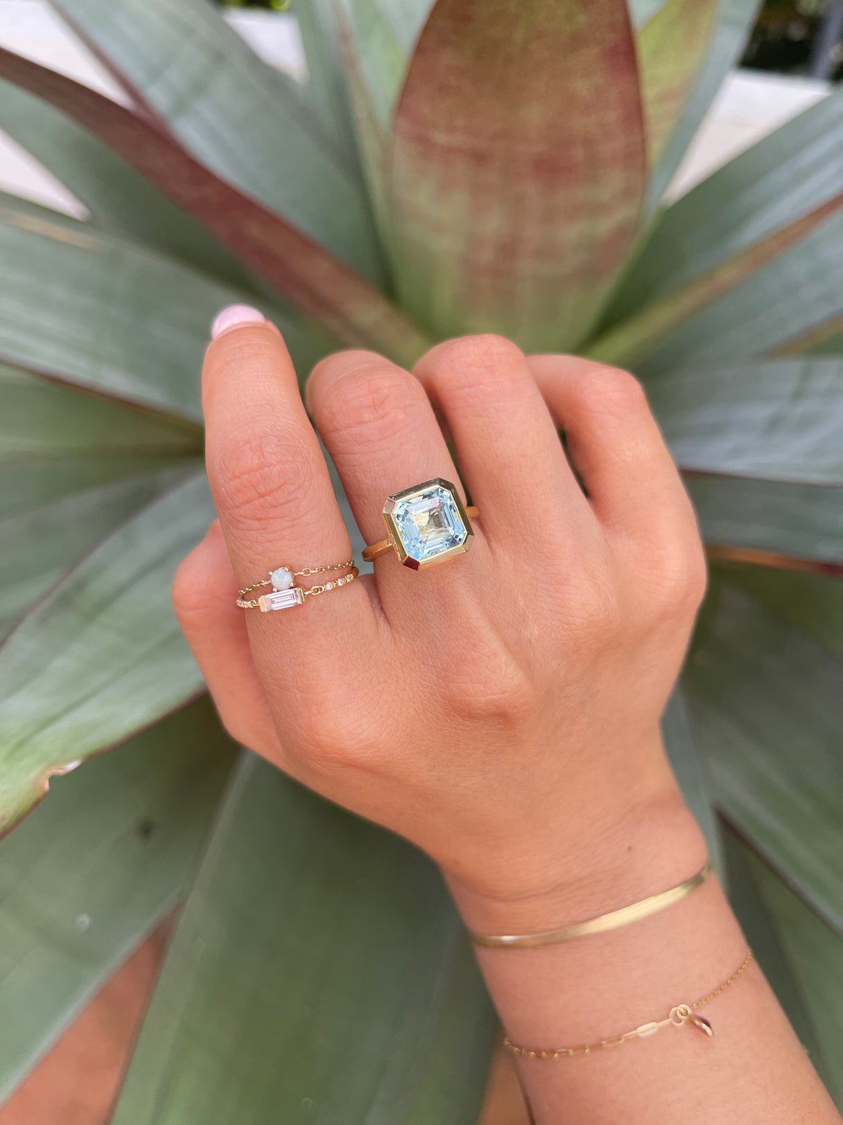 An 18k gold ring with a bezel set dazzling aquamarine gemstone. Hand cut aquamarine from Madagascar handmade by female artisans into an incredible everyday heirloom.