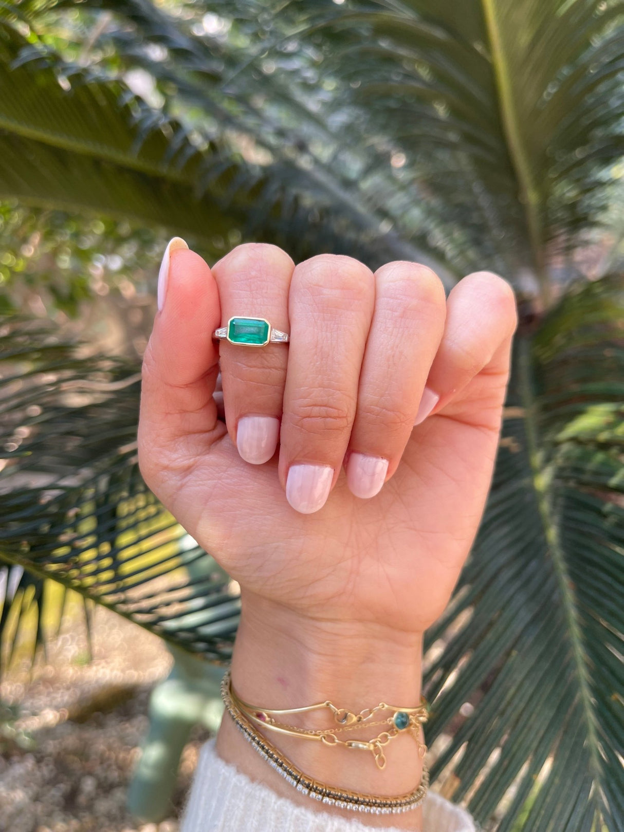 Brazilian Emerald & Diamond East West Ring 18k gold engagement ring on model