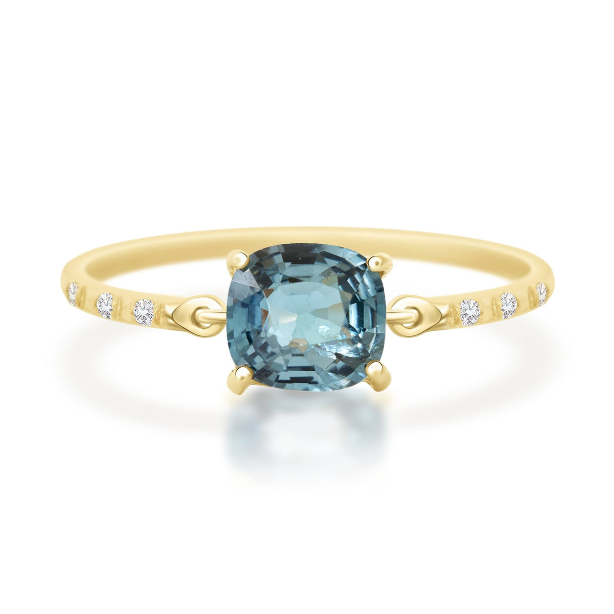 Gold ring with a blue gemstone on a white background