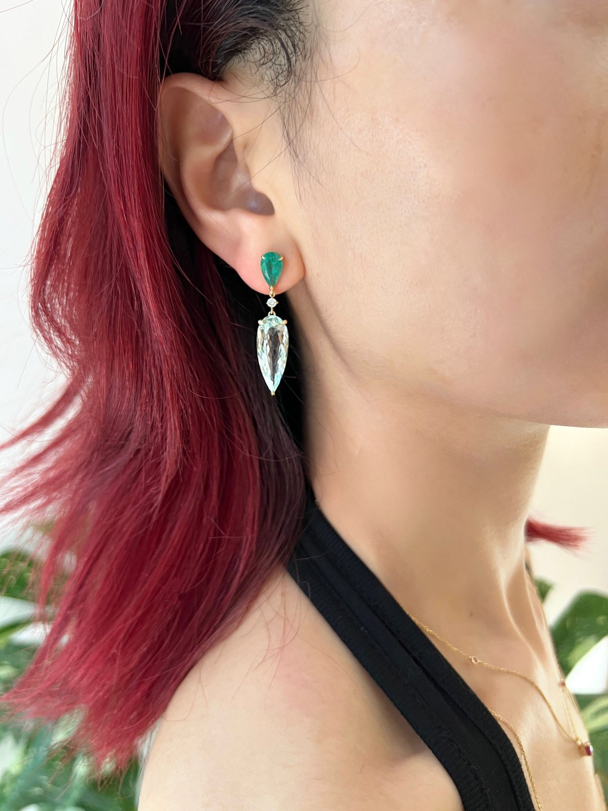 Emerald & Aquamarine Spring’s Dewdrop Earrings on model. Emerald & Aquamarine Spring’s Dewdrop Earrings. Exquisite handcrafted 18k earrings by female artisans in our Bangkok studio. Vivid green emerald paired with aquamarines from Madagascar and emeralds from Gemfields. Sustainably sourced and adds just the right pop of color.