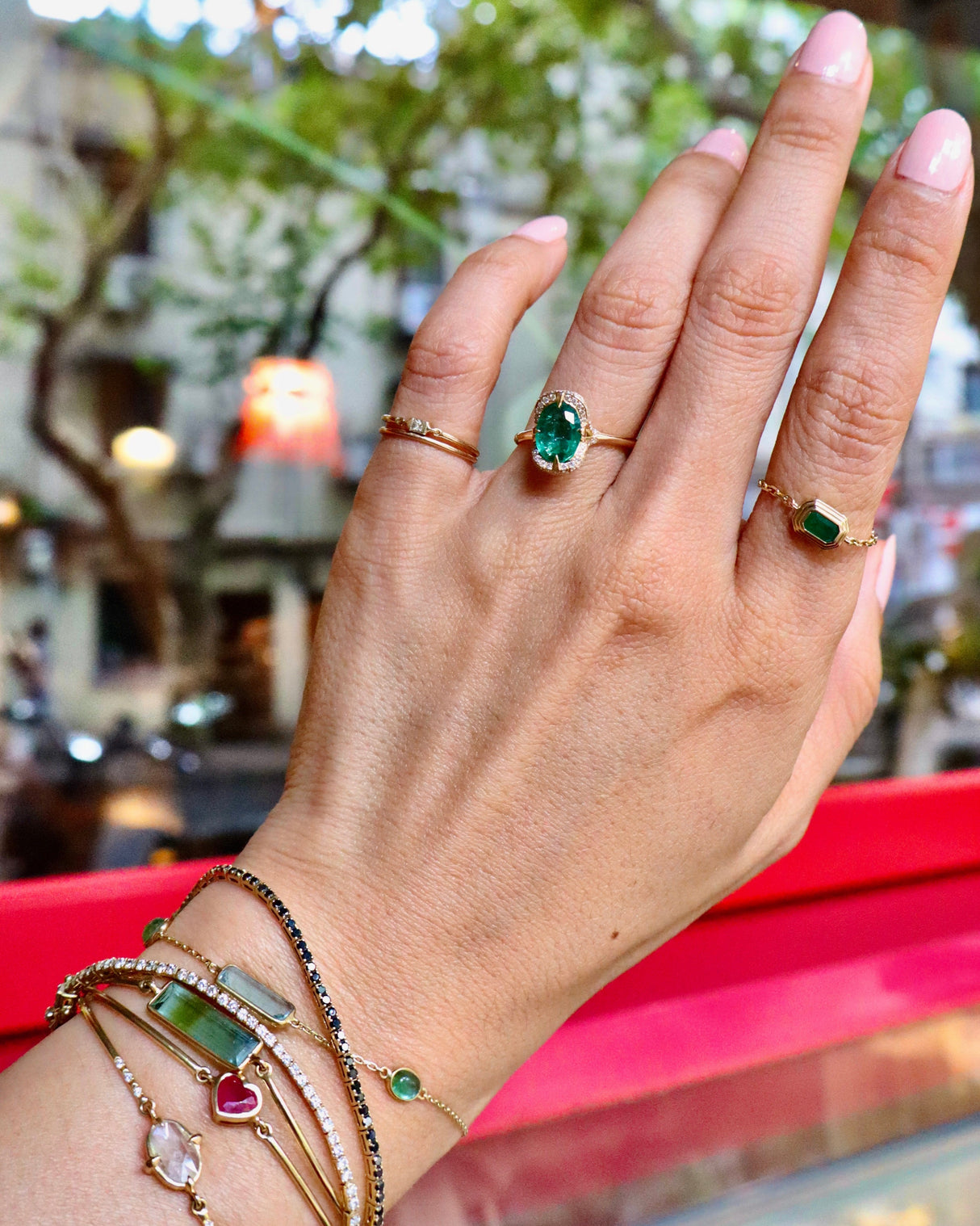 Oval_Emerald_Aurora_Ring_18K_gold_engagement_ring_on_model_2