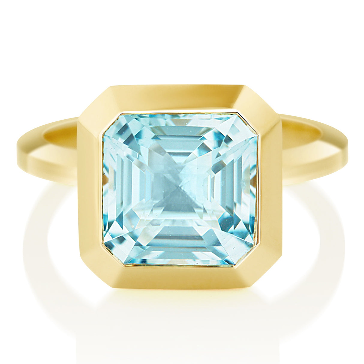 An 18k gold ring with a bezel set dazzling aquamarine gemstone. Hand cut aquamarine from Madagascar handmade by female artisans into an incredible everyday heirloom.