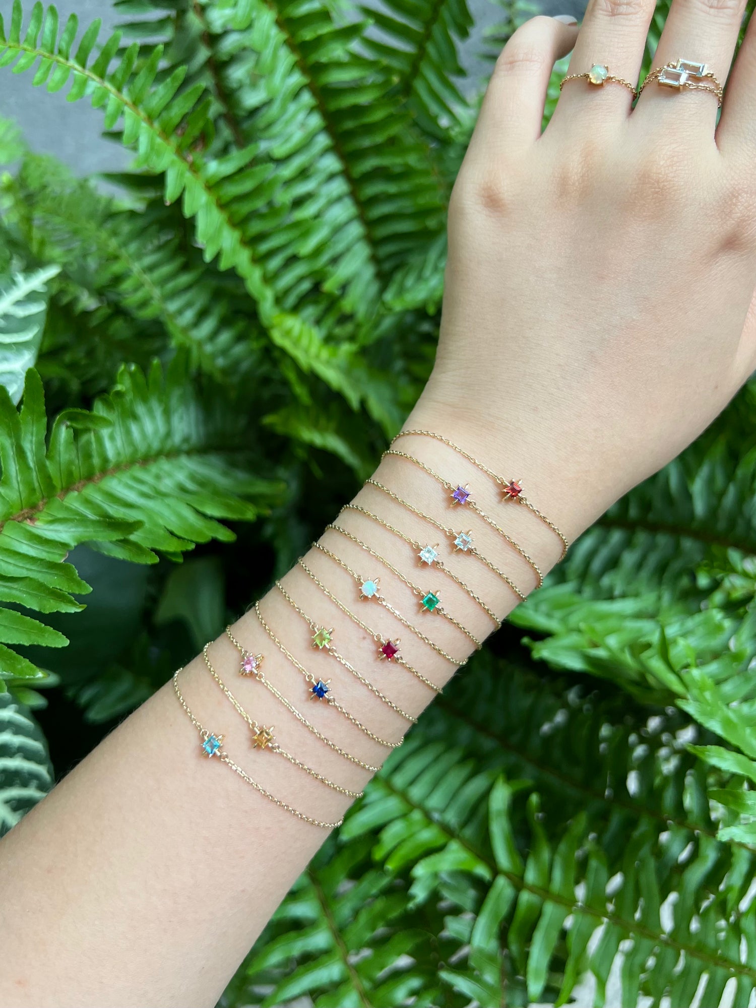 14k gold birthstone bracelets worn in bracelet stack on arm by Yi Collection