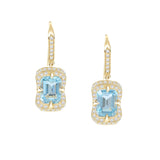 Gold earrings with aquamarine gemstones on a white background