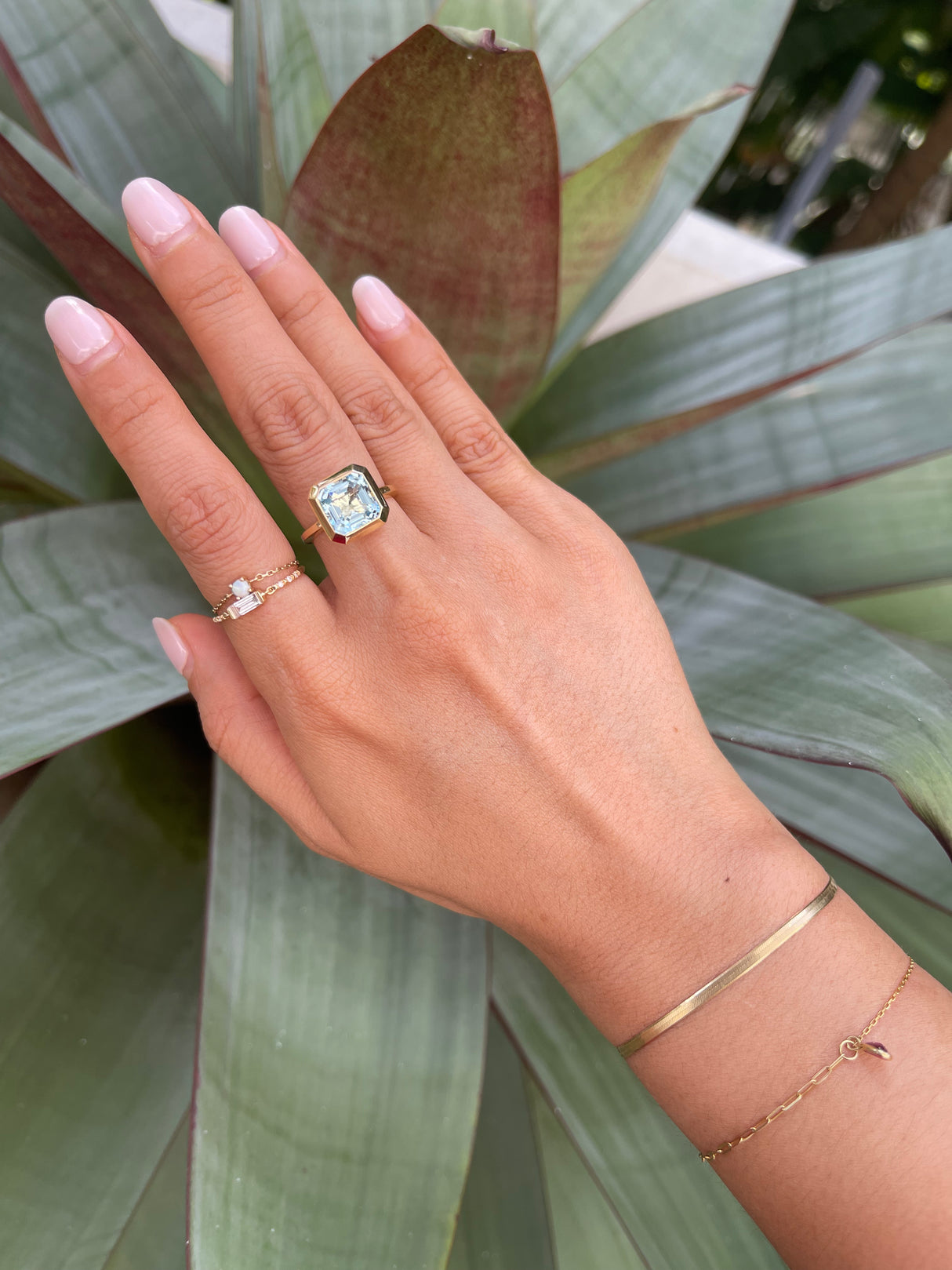 An 18k gold ring with a bezel set dazzling aquamarine gemstone. Hand cut aquamarine from Madagascar handmade by female artisans into an incredible everyday heirloom. 