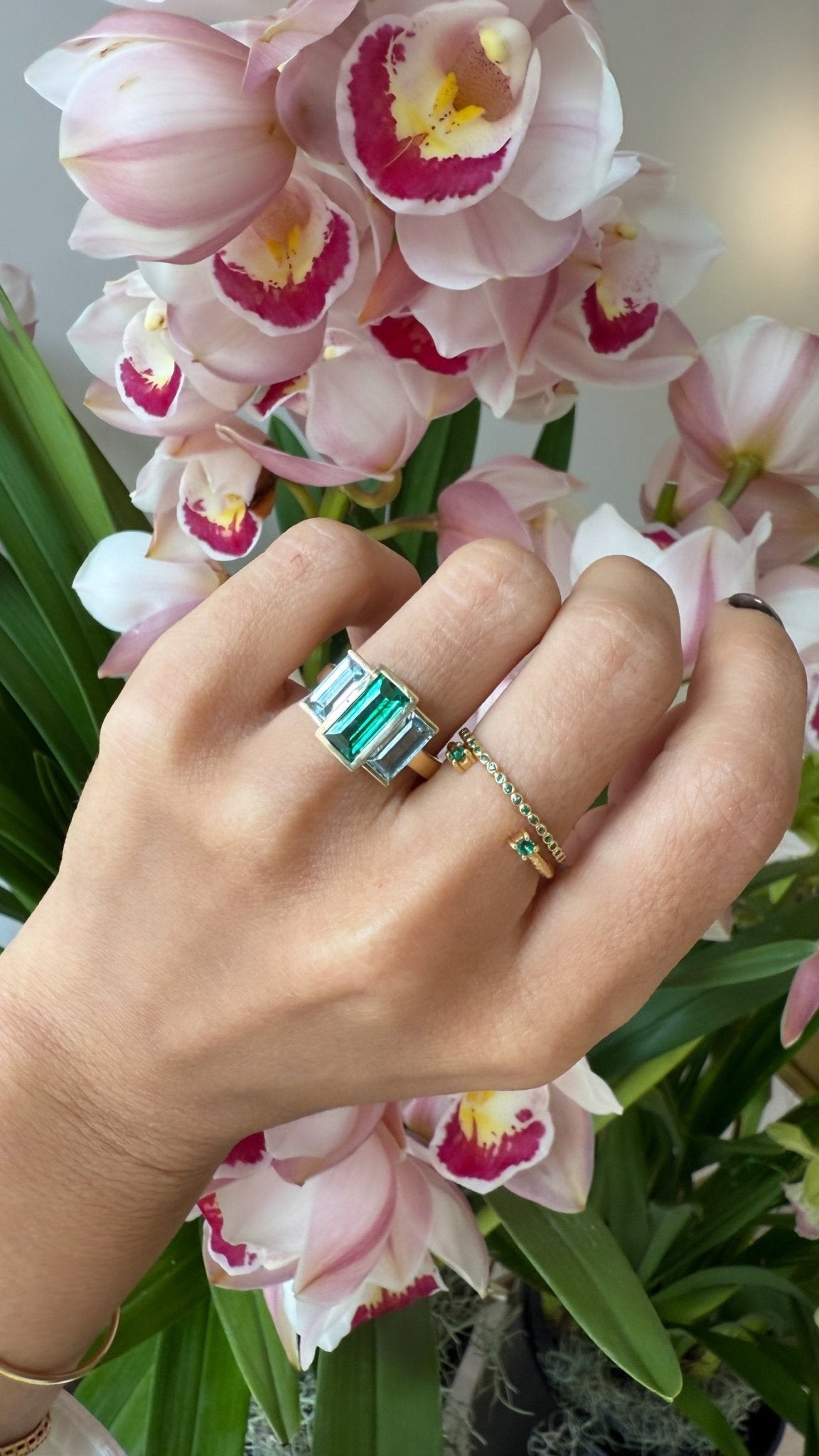 Exquisite handcrafted 18k ring by female artisans in our Bangkok studio. Vivid green emerald paired with aquamarines from Madagascar and emeralds from Gemfields. Sustainably sourced and adds just the right pop of color. 