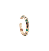 Gold hoop earring with embedded green and black stones on a white background