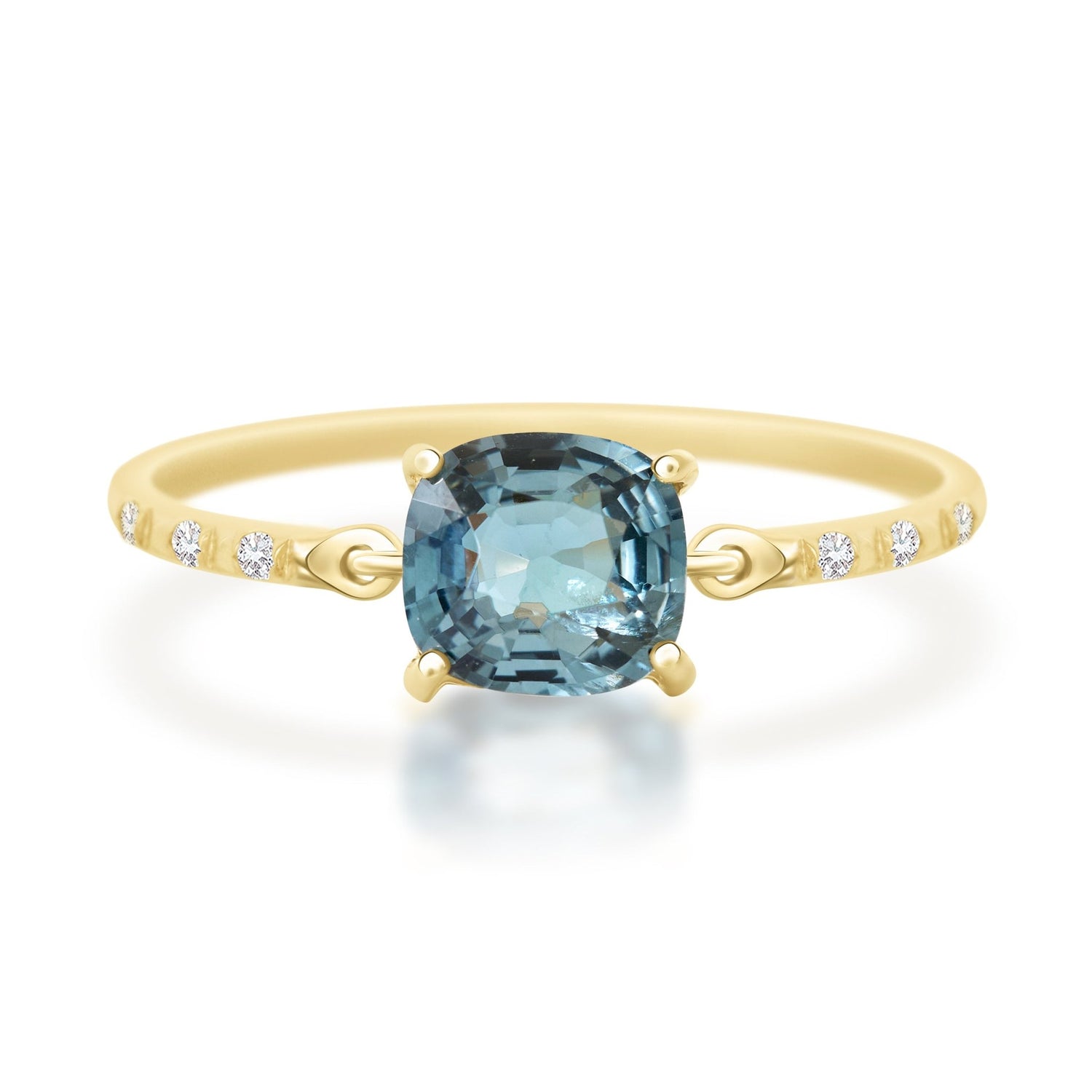 Gold ring with a blue gemstone on a white background