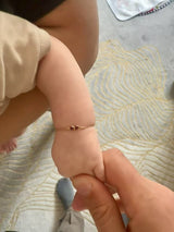 Double Happiness Ruby Baby Bracelet 18k gold stackable design on model