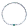 A necklace featuring a series of linked gemstones, with larger emerald cuts at the center and smaller aquamarine cuts on the sides, handmade by female artisans. Ethically sourced gemstones made into colorful wearable art. 