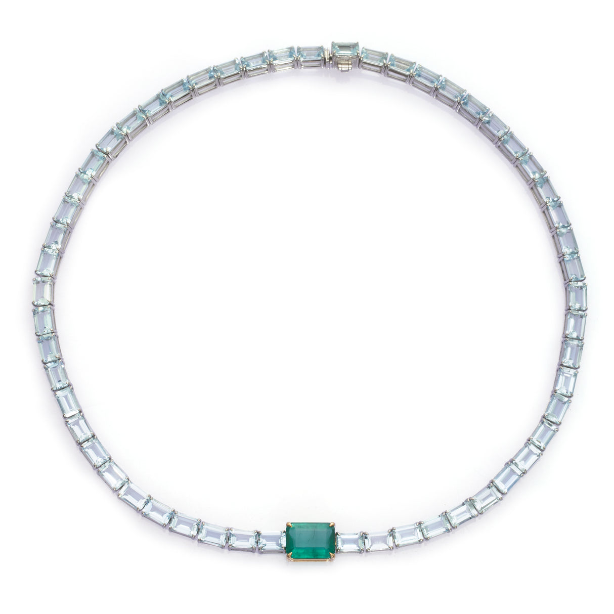A necklace featuring a series of linked gemstones, with larger emerald cuts at the center and smaller aquamarine cuts on the sides, handmade by female artisans. Ethically sourced gemstones made into colorful wearable art. 