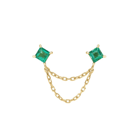 Gold earring with two emerald green gemstones on a white background