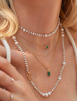 Emerald Petite Button handmade Necklace in 18k gold on model