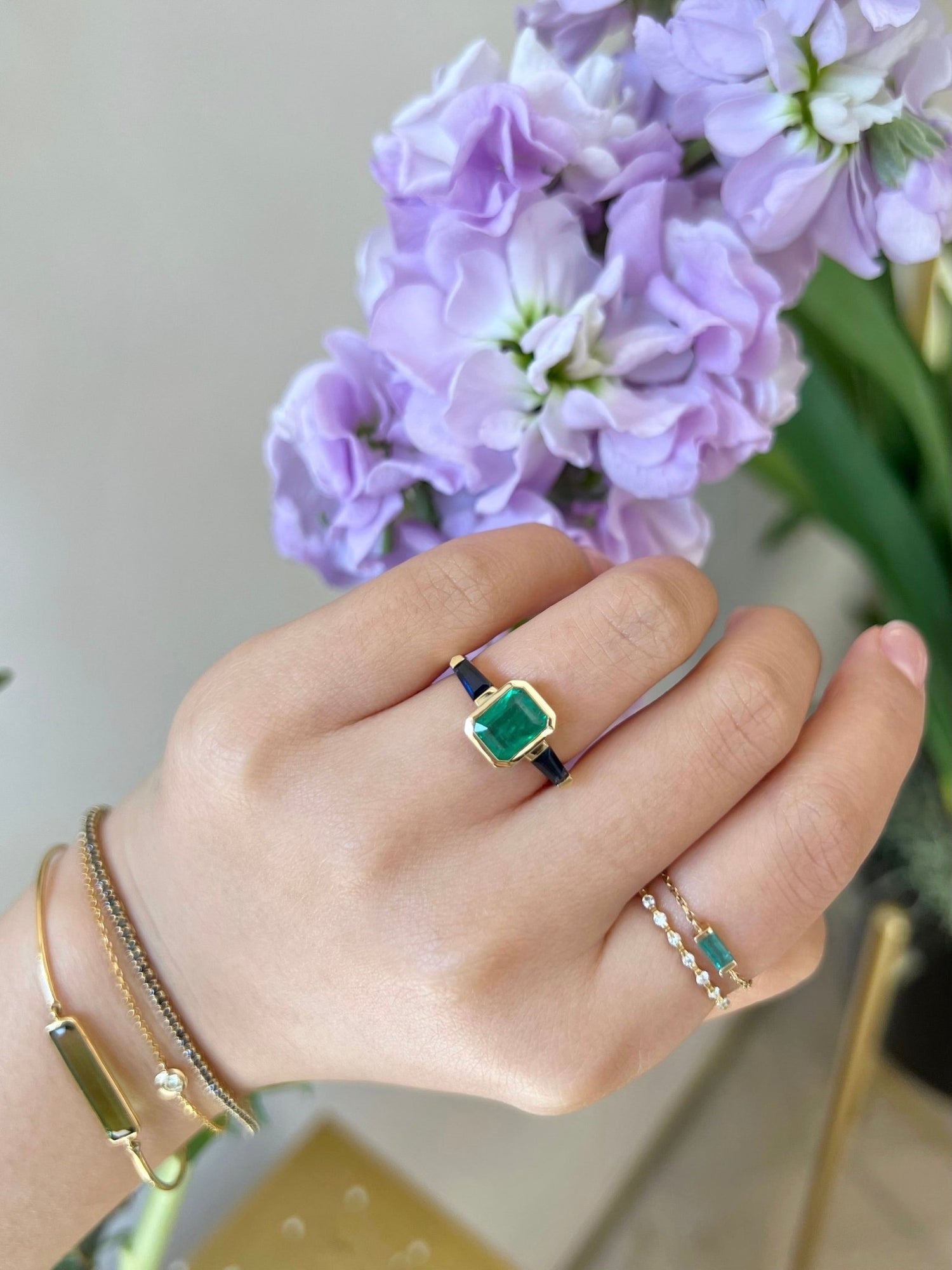 Emerald & Royal Blue Sapphire Eternal Ring 18k gold engagement ring on model