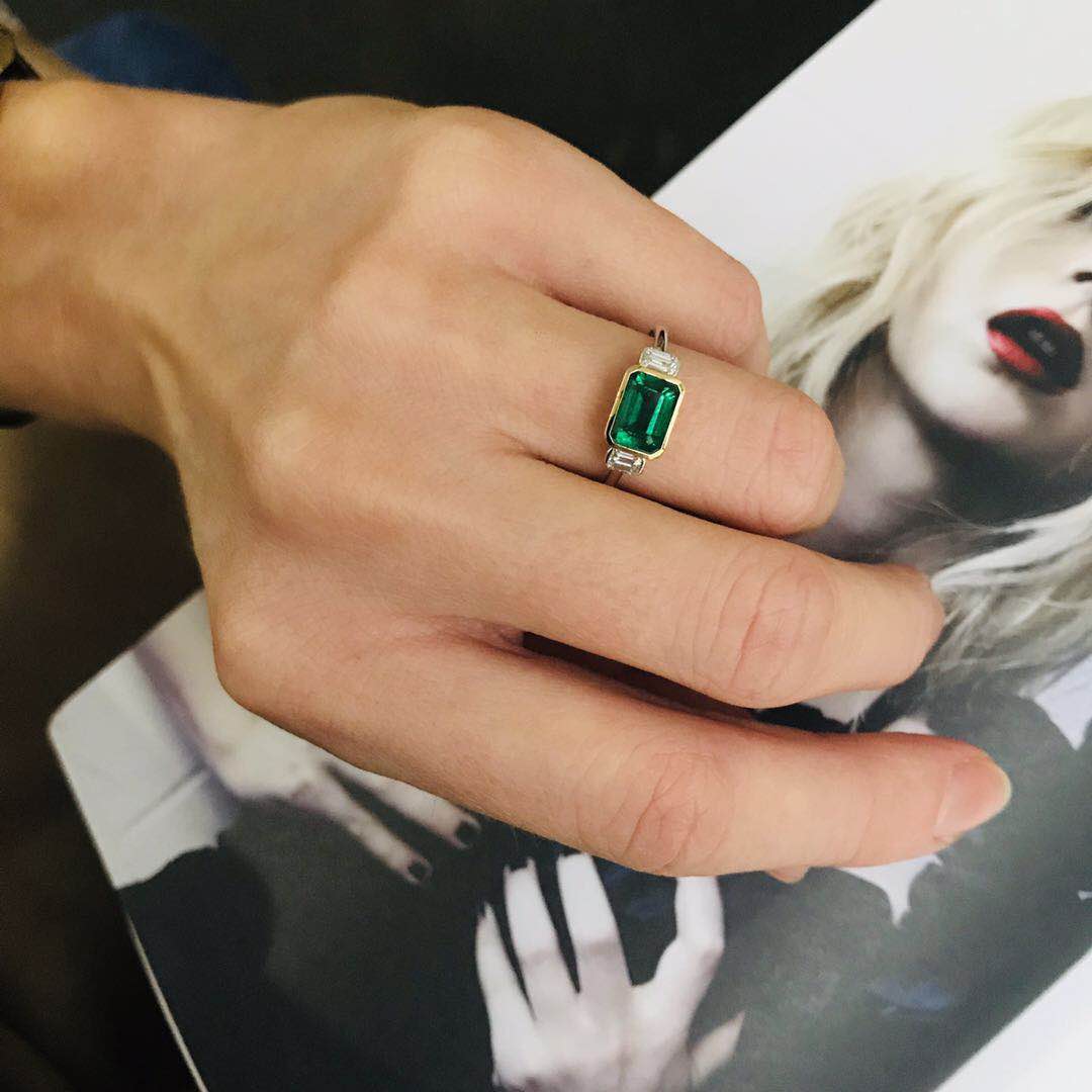 Emerald and diamond forever ring 18k gold engagement ring on hand.