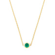 Gold necklace with a green gemstone on a white background