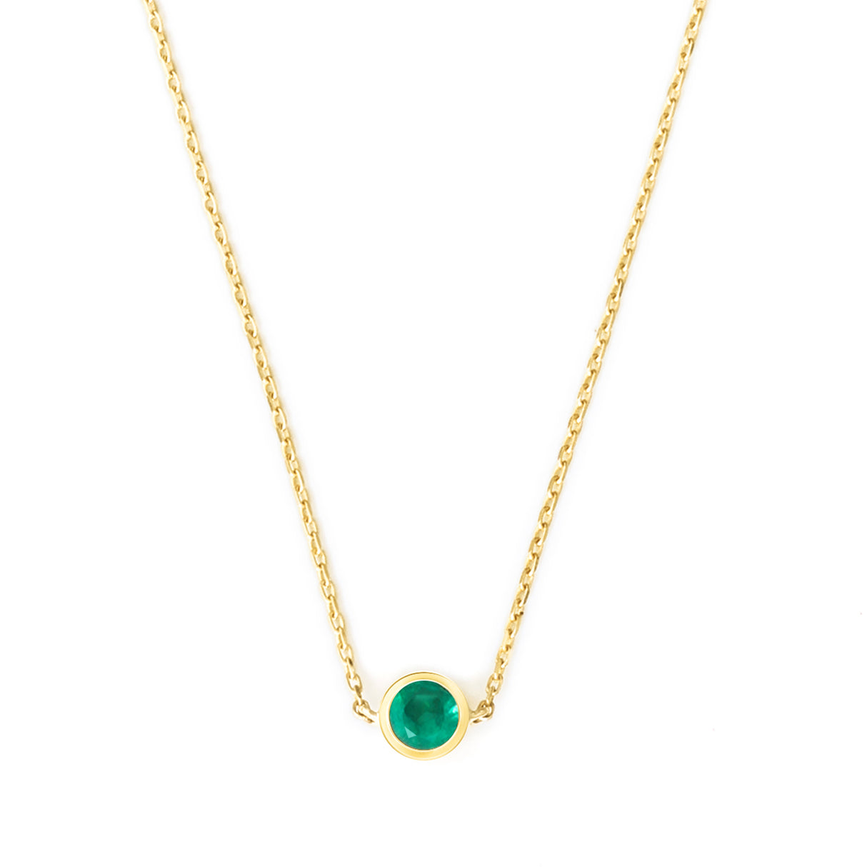 Gold necklace with a green gemstone on a white background
