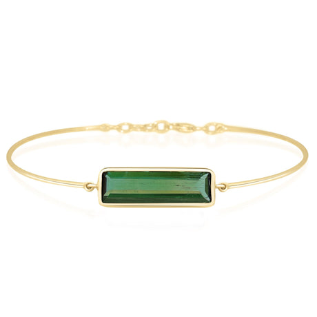 Gold bracelet with a green gemstone on a white background