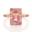 An ombré pink Tourmaline ring with a central, rectangular pink tourmaline surrounded by smaller pink tourmalines set in a gold band.