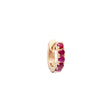 Gold ring with embedded red gemstones on a white background