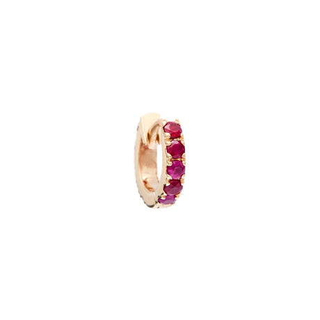 Gold ring with embedded red gemstones on a white background