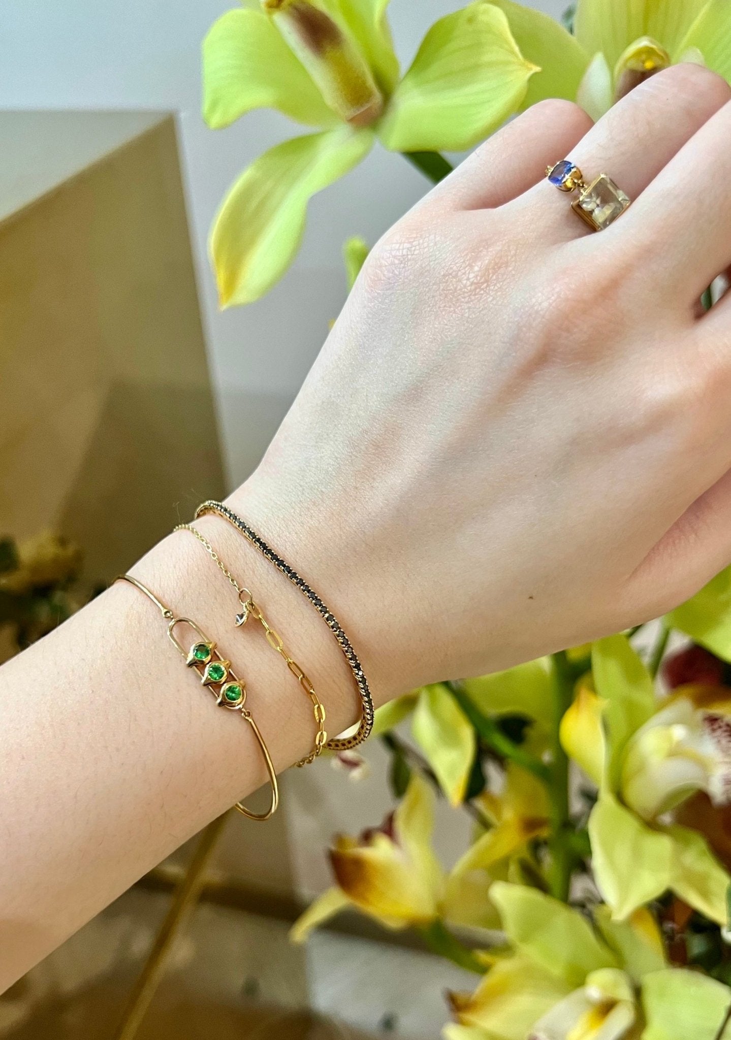 Tsavorite Orbit Bangle 18k gold stackable design on model