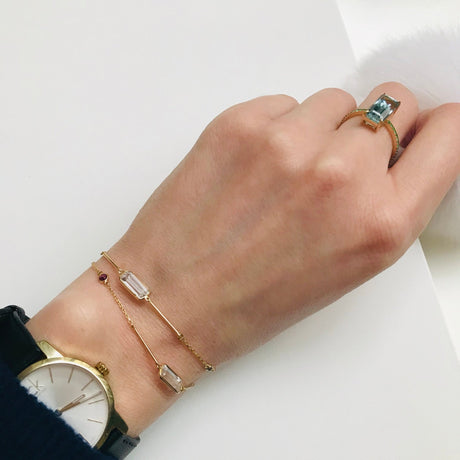 White Topaz & Ruby Bar Bracelet 18k gold stackable design on model