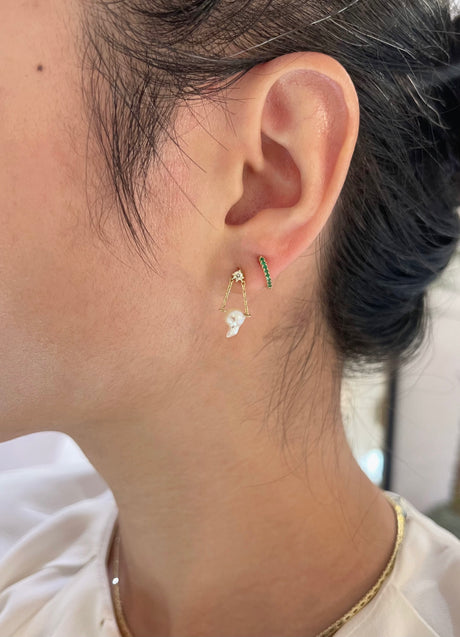Pearl and diamond earrings worn in ear stack on model
