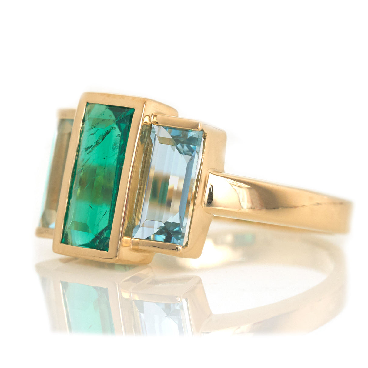 Exquisite handcrafted 18k ring by female artisans in our Bangkok studio. Vivid green emerald paired with aquamarines from Madagascar and emeralds from Gemfields. Sustainably sourced and adds just the right pop of color. 