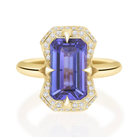 Gold ring with a purple gemstone and diamond accents on a white background