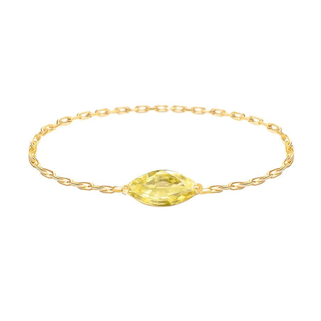 Gold chain ring with a yellow sapphire on a white background Yi Collection