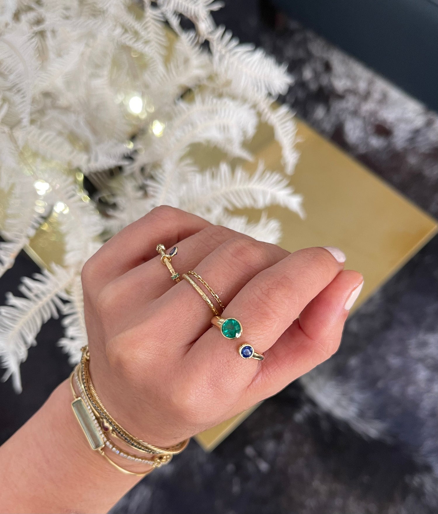 Emerald & Sapphire Toi & Moi Ring 18k gold stackable ring on model 2