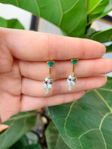 A pair of dangle earrings featuring vivid green tsavorite garnet at the top and clear Aquamarine stones in a teardrop shape at the bottom, set in gold mounting. Handmade by female artisans with sustainably mined gemstones 